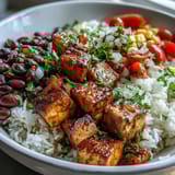 Brightly colored burrito bowl base with fluffy rice, black beans, and seasoned chicken, topped with pico de gallo and avocado for a fresh meal prep option.