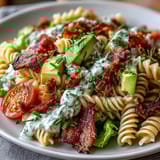 Colorful BLT pasta with avocado ranch dressing, loaded with bacon, cherry tomatoes, and crunchy romaine lettuce.  