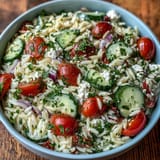 Close-up of refreshing Summer Orzo Salad with Feta and Lemon, tossed with olives and herbs.
