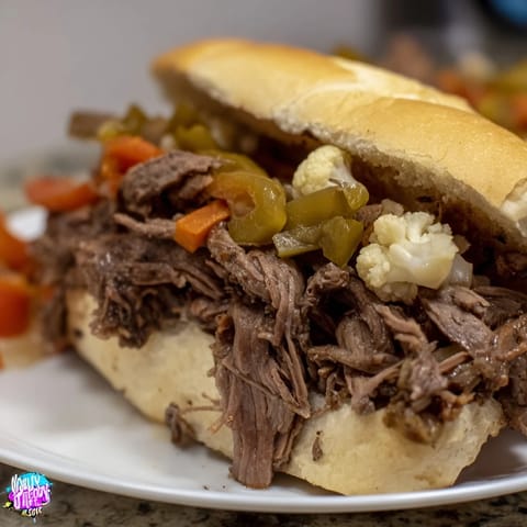 Italian Beef Sandwich dipped in savory au jus, served hot and ready for a messy, delicious bite.