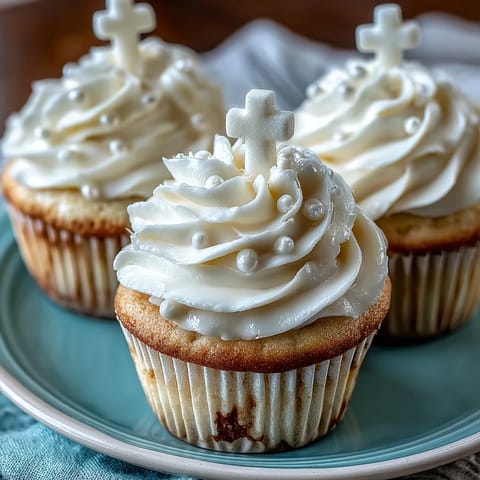 Communion Cupcakes with White Fondant Cross Toppers topped with creamy vanilla buttercream frosting.
