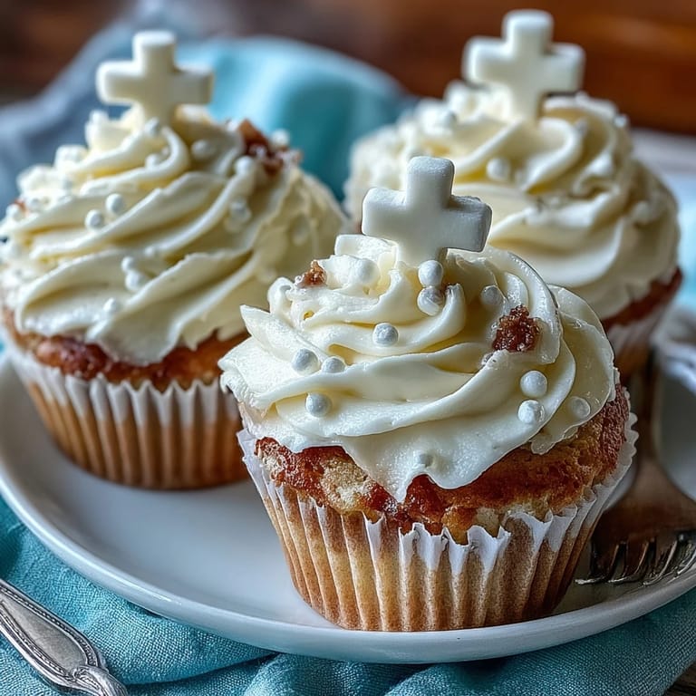 Delicious vanilla cupcakes with smooth buttercream and delicate fondant cross toppers for special occasions.