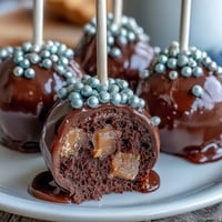 Festive Pot of Gold Cake Pops with black candy coating and shimmering gold sprinkles, perfect for St. Patrick's Day celebrations.